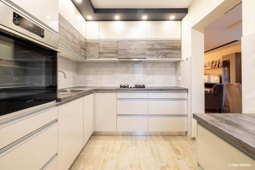 a kitchen with white cabinets and stainless steel appliances at Ranch Zeru 