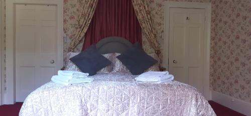 a bedroom with a bed with white sheets and blue pillows at The Circus Apartment in Bath