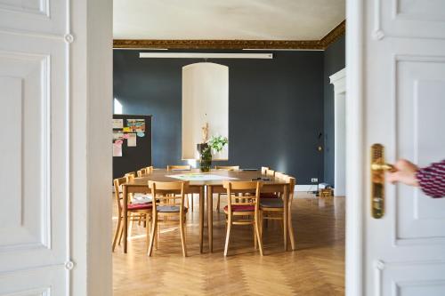 a dining room with a table and chairs at Gut Pohnstorf in Alt Sührkow