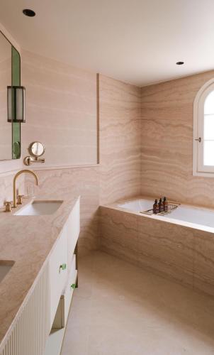 a bathroom with a tub and a sink at Villa Miraé by Inwood Hotels - Cap d'Antibes in Antibes