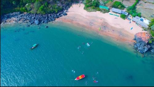 an aerial view of a beach with boats in the water at Bhadrakali Beach Front Stay in Gokarn