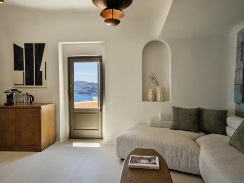 a living room with a couch and a window at Andronis Luxury Suites in Oia