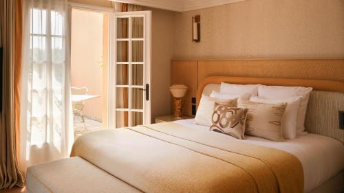 a bedroom with a large white bed with pillows at Villa Miraé by Inwood Hotels - Cap d'Antibes in Antibes