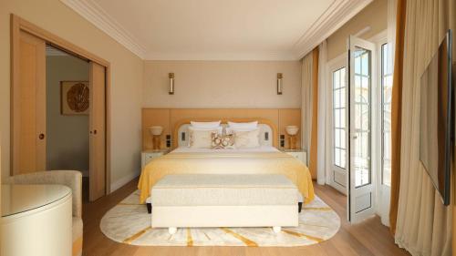 a bedroom with a large bed with a yellow bedspread at Villa Miraé by Inwood Hotels - Cap d'Antibes in Antibes