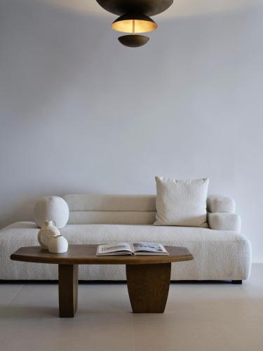 a living room with a couch and a coffee table at Andronis Luxury Suites in Oia