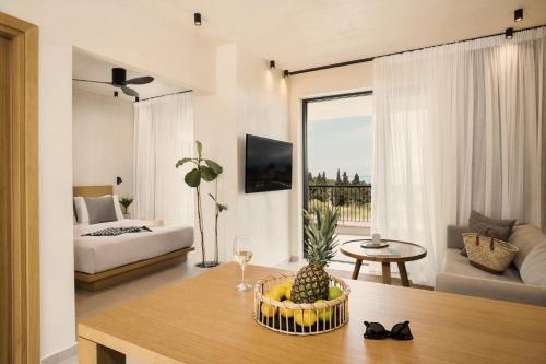 a living room with a couch and a table with a pineapple at Pnoes Luxury Suites in Paliouri