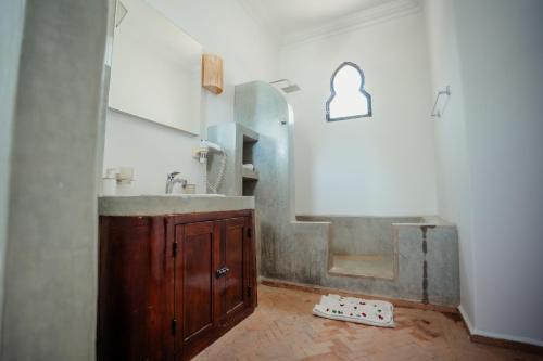 a bathroom with a sink and a mirror at DOMAINE DU DOUAR in Marrakech