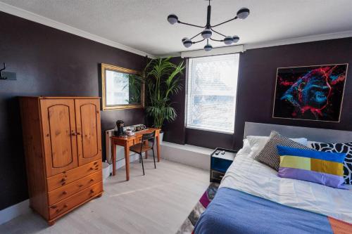 a bedroom with a bed and a desk in it at The Driftwood Inn in Starcross