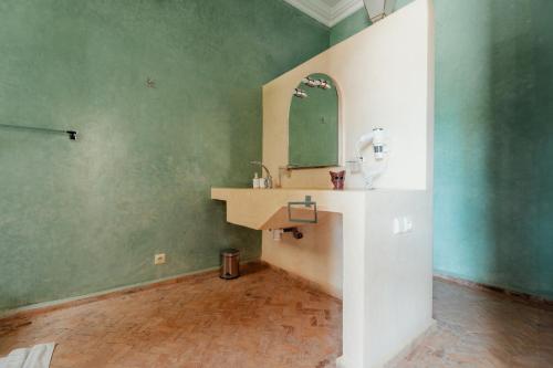 a bathroom with a sink and a mirror at DOMAINE DU DOUAR in Marrakech