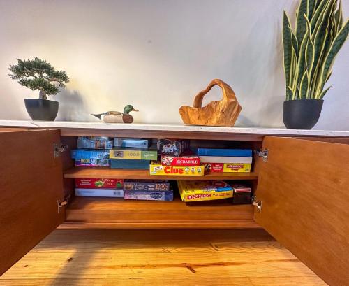 a book shelf with books and potted plants at Entire cabin on Lake Sequoyah in Highlands