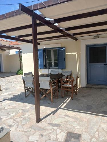 a wooden pergola with a table and chairs on a patio at Beautiful house ideal for families in Varos