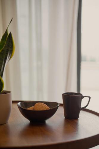 a bowl of peanuts and two cups on a table at Pnoes Luxury Suites in Paliouri