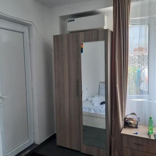 a bedroom with a wooden cabinet with a mirror at centrhouse in K'obulet'i