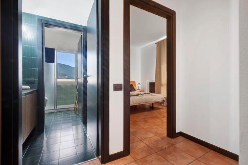 a hallway with a door leading to a bedroom at Lake Como Design Home in Lecco