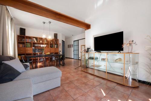 a living room with a couch and a tv at Lake Como Design Home in Lecco