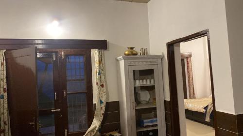 a room with a mirror and a dresser and a door at Surya hills view in Jāmb