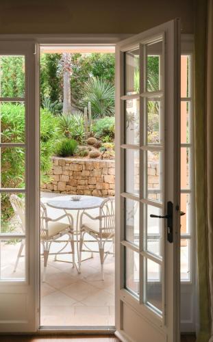 an open door to a patio with a table and chairs at Villa Miraé by Inwood Hotels - Cap d'Antibes in Antibes
