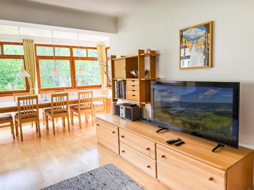 a living room with a large flat screen tv at Villa Schnuck - das rote Ferienhaus in Bad Gastein
