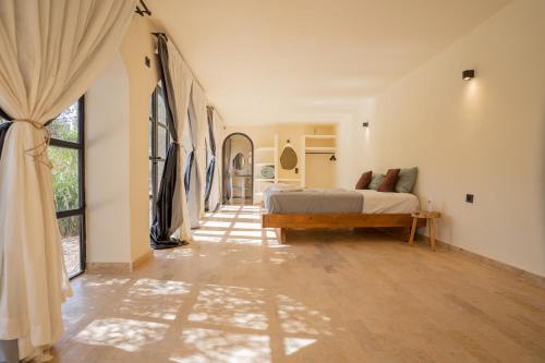 a bedroom with a bed and a large window at Villa Daïs - Marrakech in Marrakech