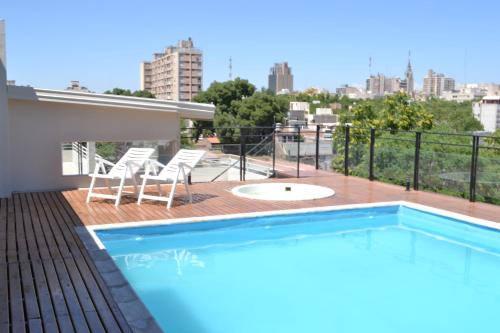a swimming pool on the roof of a building at Gran Hotel Dakar in Mendoza