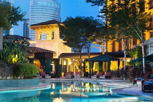 a swimming pool in a city with a building at Sheraton Imperial Kuala Lumpur Hotel in Kuala Lumpur