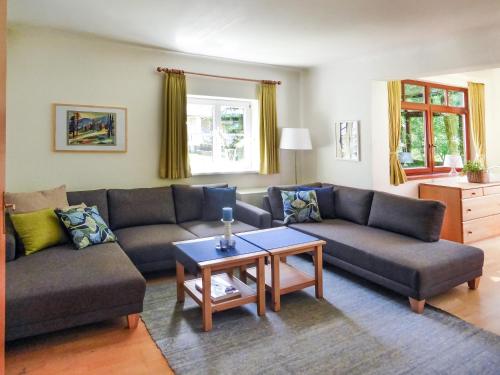 a living room with two couches and a table at Villa Schnuck - das rote Ferienhaus in Bad Gastein