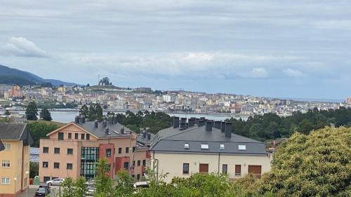 a view of a city with houses and a river at Piso Mirador de San Cosme in San Cosme de Barreiros