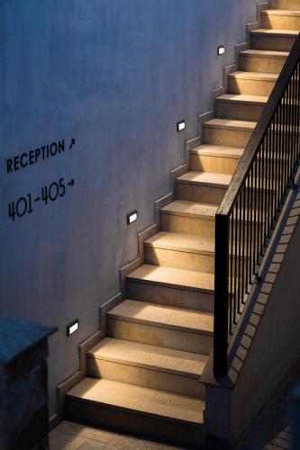 a staircase with wooden steps in a building at Pnoes Luxury Suites in Paliouri