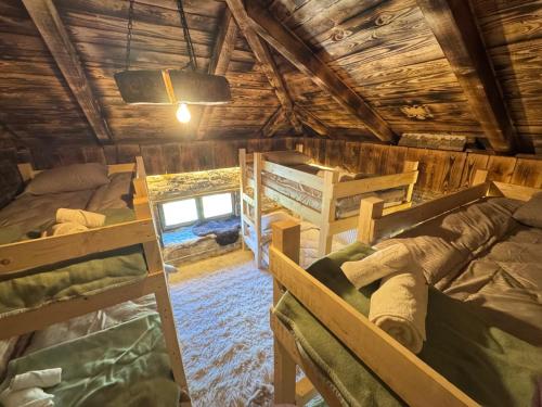 a room with four bunk beds in a cabin at Guest house Stanet 1Maj in Tetovo
