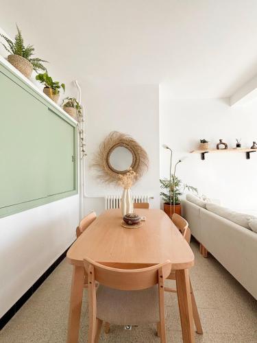 a living room with a table and a couch at Charming duplex with stunning view in LʼAgha