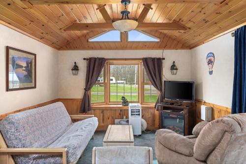 a living room with a couch and a tv at Vacation Home Rental PM 51 in Russell