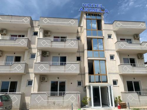 a building with balconies on the side of it at Hotel Armela in Velipojë