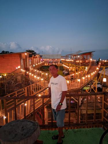 a man standing on top of a building with lights at Varvara hill in Cigugur