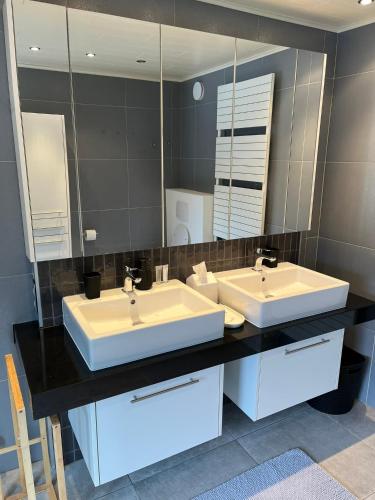 a bathroom with two sinks and a large mirror at Business Accommodation 'Urban Living' Intimate in Geel