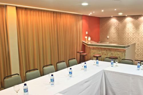 a conference room with a long table and chairs at Hotel Meridional in Fortaleza