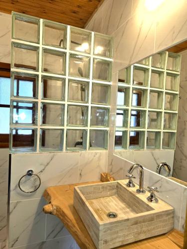 a bathroom with a wooden sink and a window at Hotel La Cumbrecita in La Cumbrecita