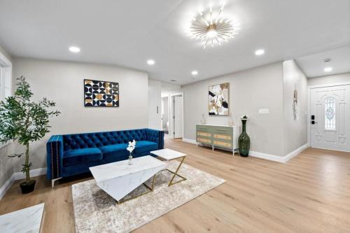 a living room with a blue couch and a table at Xlnc Exotic home13824 Powers Rd in Poway