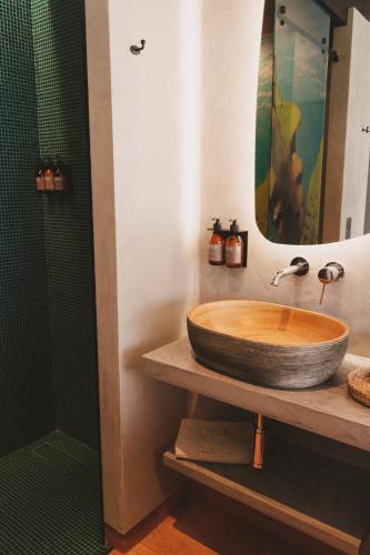 a bathroom with a wooden sink and a shower at Santa Cruz - Movement & Nature House in Santa Cruz