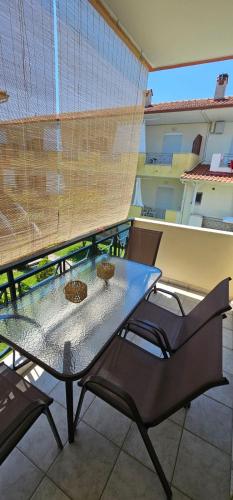 a table on a balcony with two baskets on it at Nicholas House in Siviri