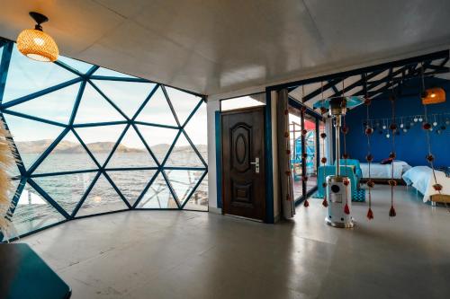 a room with a bed and a view of the water at Uros Titicaca Lodge in Puno