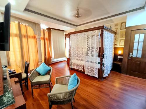a living room with a couch and chairs and a table at Hotel Sun Grand in Agra