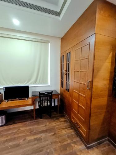 an office with a wooden desk and a window at Hotel Sun Grand in Agra