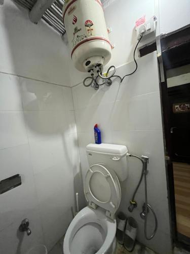 a bathroom with a toilet with a water tank at Guru guest house in Leh