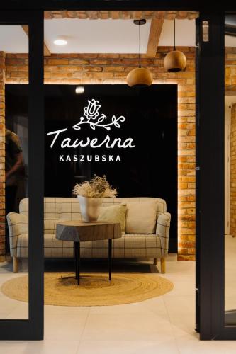 a living room with a couch and a table at Tawerna Kaszubska in Ostrzyce
