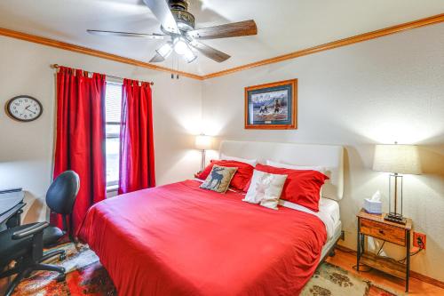 a bedroom with a red bed with a ceiling fan at Family Retreat 2 Mi to Santas House Pets Welcome in North Pole