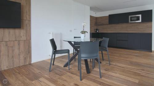 a dining room with a black table and chairs at Hotel Corte Santa Libera in San Fedele Intelvi