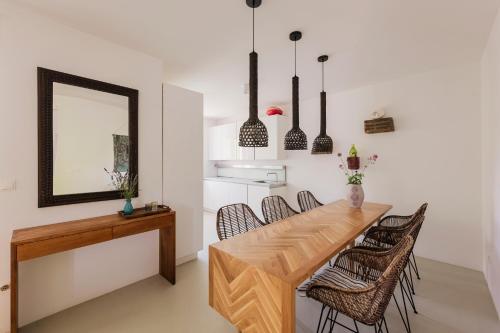 a dining room with a wooden table and chairs at Galboka Residence in Nerezine
