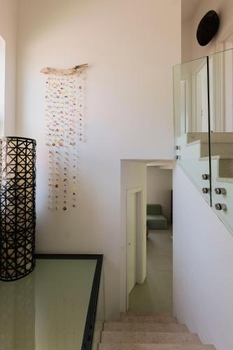 a room with a wall with a bunch of wine bottles at Galboka Residence in Nerezine