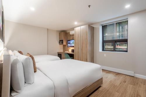 a hotel room with two beds and a window at Olympia Hotel by Lodgo in Montréal