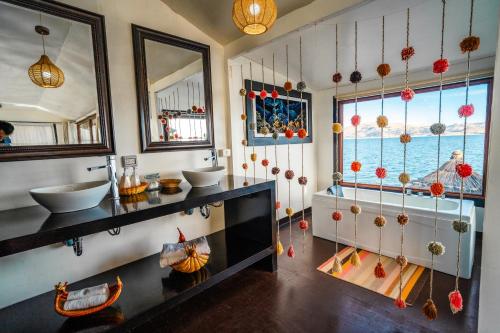 a bathroom with two sinks and a large window at Uros Titicaca Lodge in Puno